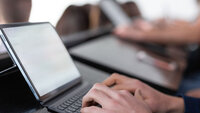 Close up of tablet with keyboard in classroom with students