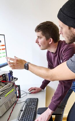 Zwei Doktoranden im Labor für Elektrische Maschinen, Leistungselektronik und Antriebe.