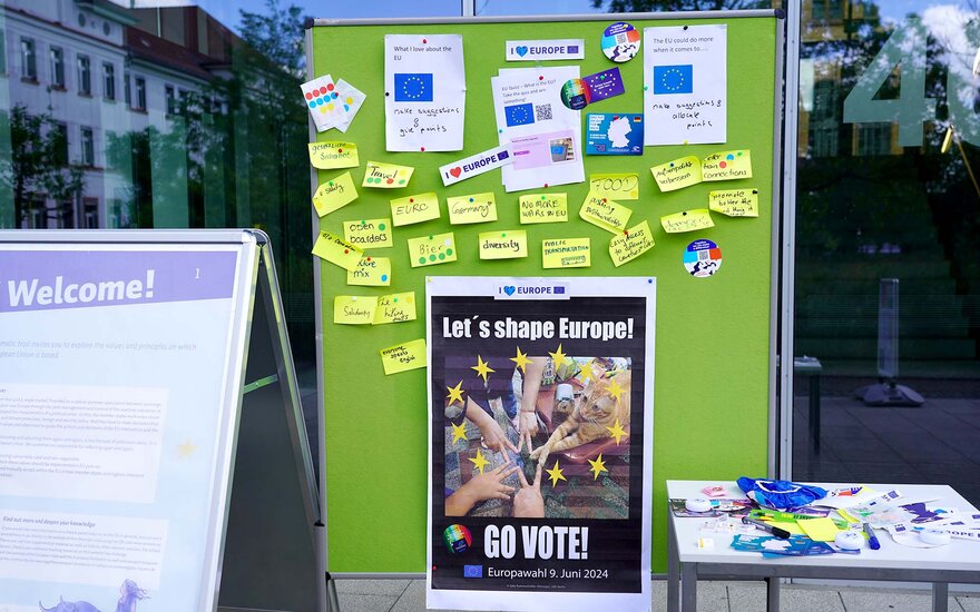 A green poster says "Go vote!"