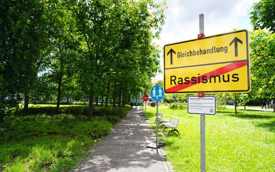 a sign saying "justice" yes, "racism" no